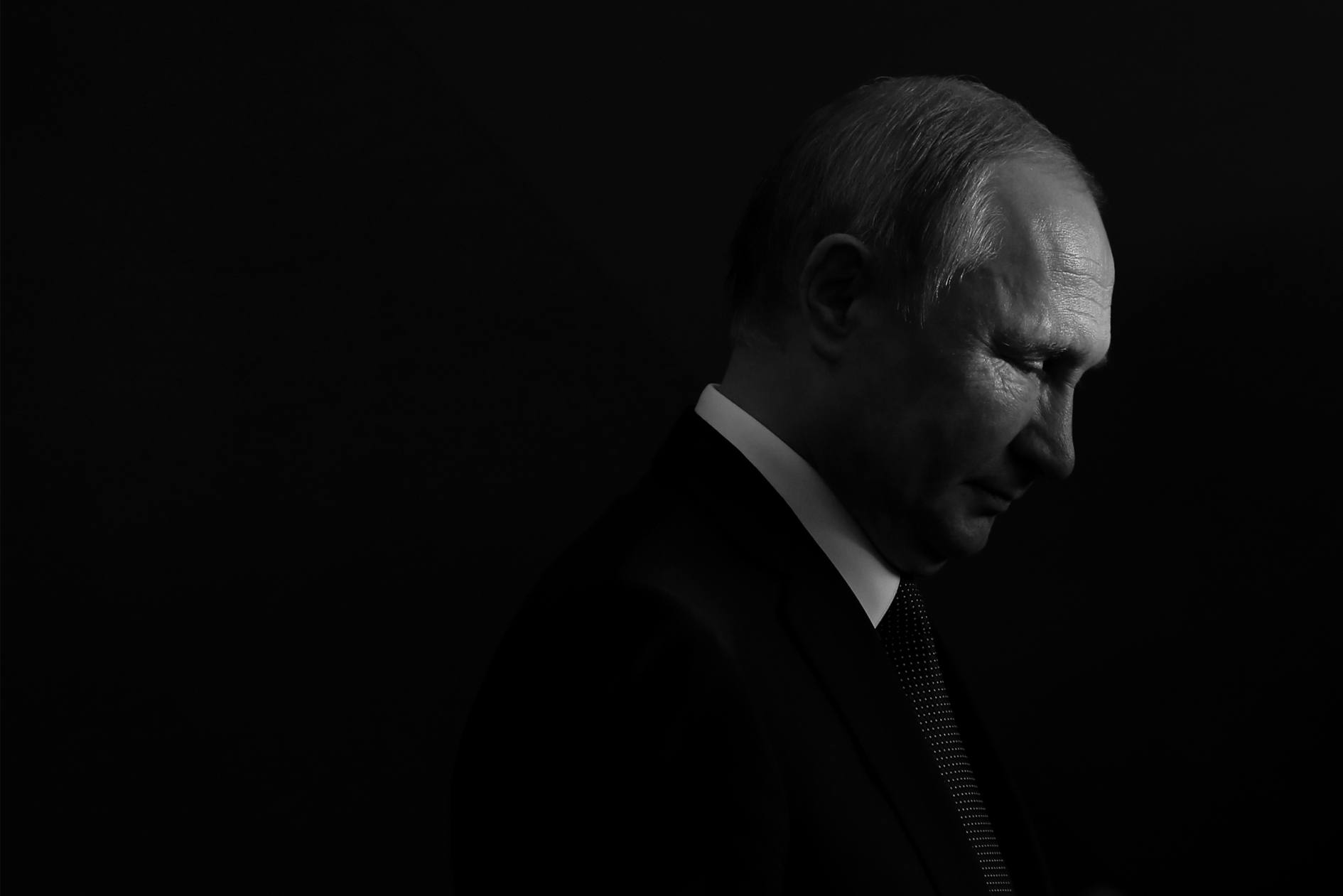 President of Russia Vladimir Putin, standing in the dark